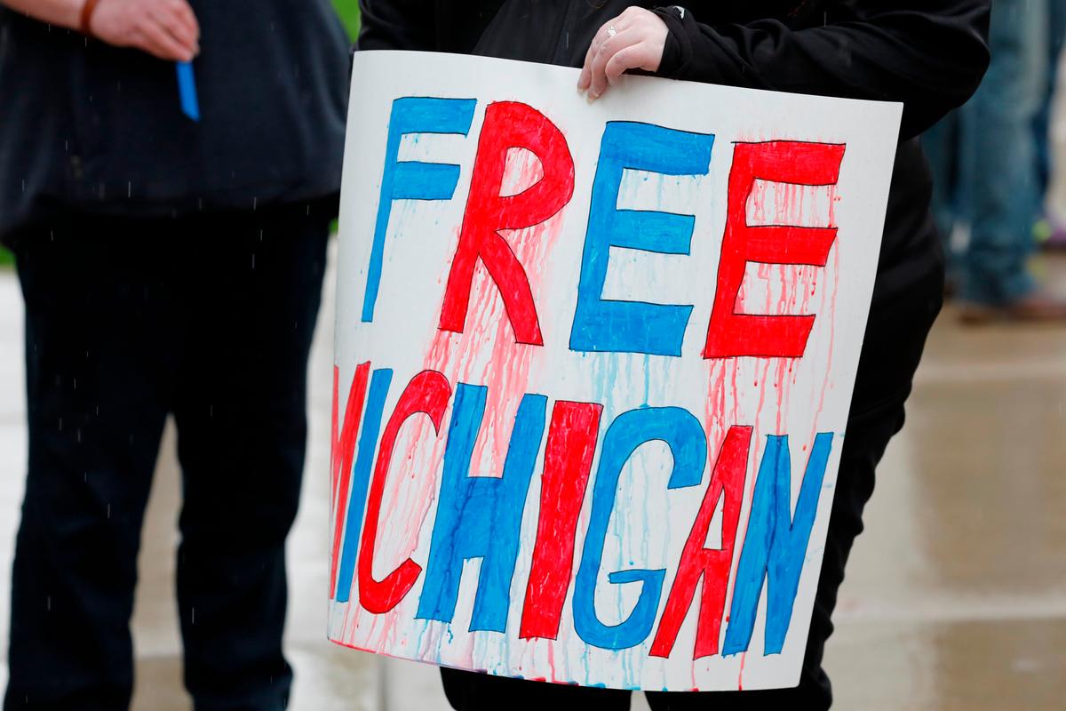 Demonstrators take part in an "American Patriot Rally," organized on the steps of the Michigan State Capitol in Lansing, Mich., on April 30, 2020. Michigan's stay-at-home order declared by Democratic Gov. Gretchen Whitmer is set to expire after May 15. (Jeff Kowalsky/AFP/Getty Images)