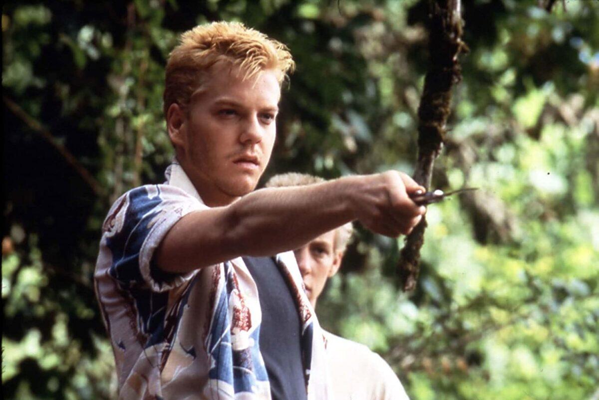 Ace (Kiefer Sutherland, L), the alpha bully, and Charlie Hogan (Gary Riley) in “Stand by Me.” (Columbia Pictures)