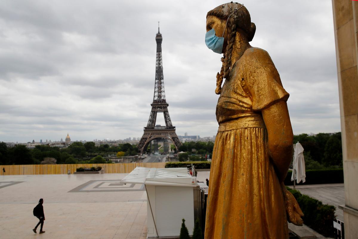 A statue wears a mask along Trocadero square close to the Eiffel Tower in Paris, France, on May 4, 2020. (Christophe Ena/AP Photo)