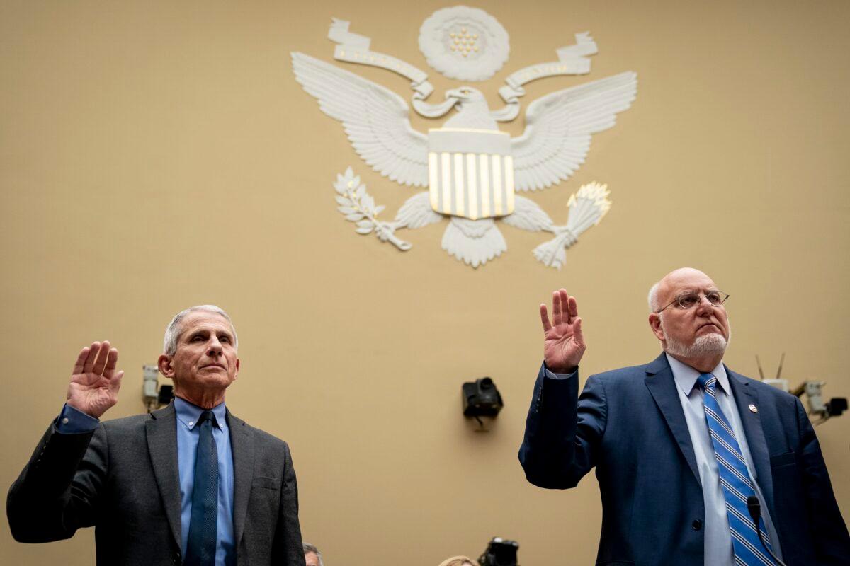 Dr. Anthony Fauci and Dr. Robert Redfield are sworn in during a House Oversight and Reform Committee hearing concerning government preparedness and response to the CCP virus, in the Rayburn House Office Building in Washington on March 11, 2020. (Drew Angerer/Getty Images)