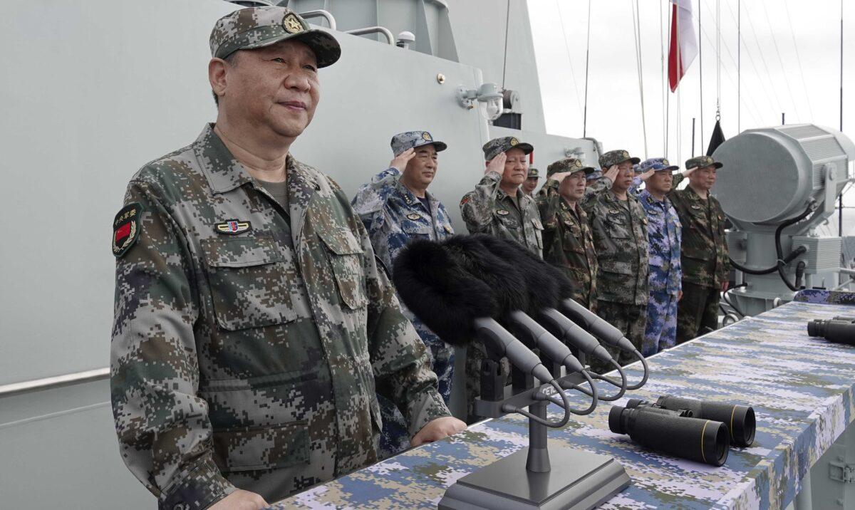 Chinese leader Xi Jinping (L) speaks after inspecting the Chinese People's Liberation Army (PLA) Navy fleet in the South China Sea on April 12, 2018. (Li Gang/Xinhua via AP)
