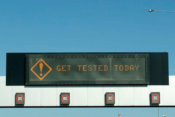 The roadway gantry signs on the Westgate Freeway display messages about COVID-19 testing on May 5, 2020 in Melbourne, Australia. (Darrian Traynor/Getty Images)
