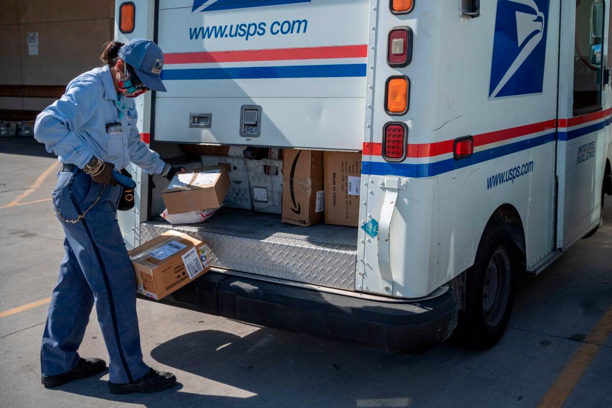 United States Postal Service mail carrier Lizette Portugal finishes loading her truck amid the COVID-19 pandemic in El Paso, Texas, on April 30, 2020. (Paul Ratje/AFP via Getty Images)