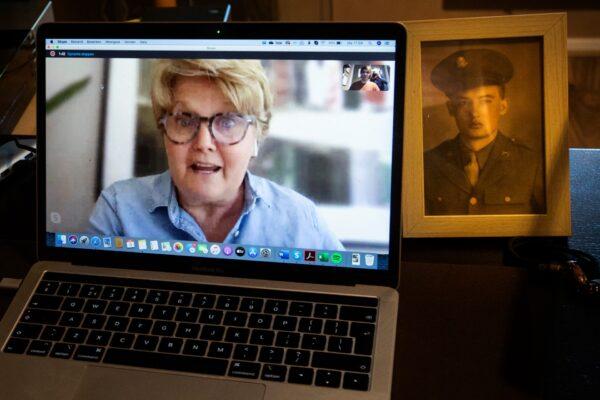 Historian Sebastiaan Vonk, upper right image on screen, has a picture of Staff Sgt. Maurice Gosney, (R), on his desk as he talks to his niece Kristin Wright, from St. Louis, Mo., during a Skype talk in Hardinxveld-Giessendam, Netherlands, on May 4, 2020. (Peter Dejong/AP Photo)