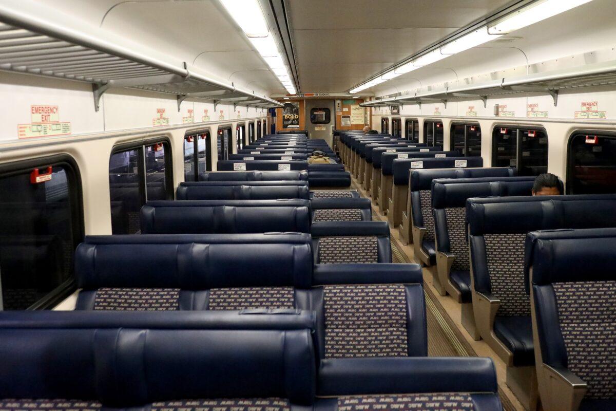 Three passengers ride a usually packed commuter MARC train out of Penn Station en route to Washington in Baltimore, Maryland on April 9, 2020. (Rob Carr/Getty Images)