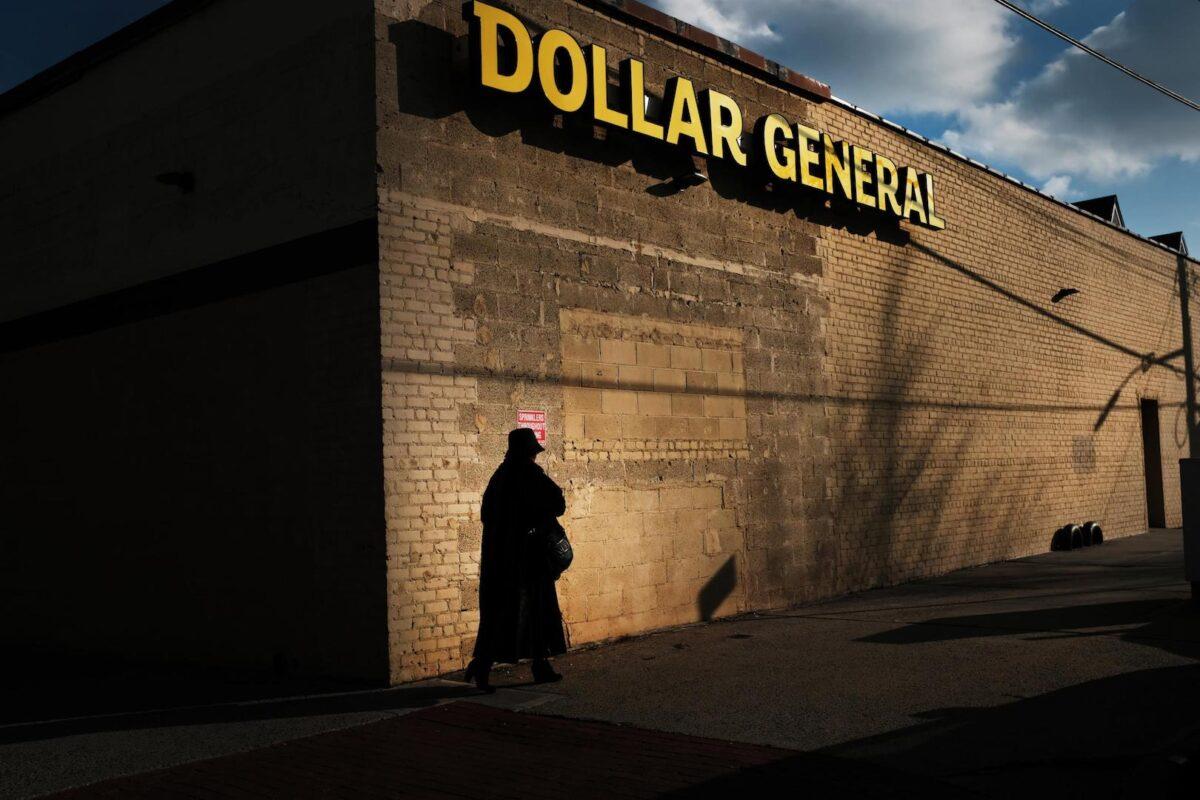 A woman walks by a Dollar General store on December 11, 2018 in the Brooklyn borough of New York City.