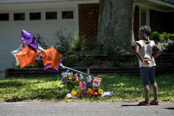 A young girl looks at a memorial for Ahmaud Arbery near where he was shot and killed, in Brunswick, Ga., on May 8, 2020. (Sean Rayford/Getty Images)
