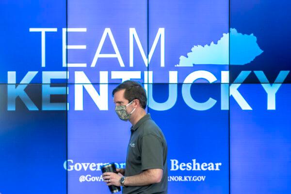 Kentucky Gov. Andy Beshear walks to the podium during a media conference at the state’s Emergency Operations Center at the Boone National Guard Center in Frankfort, Ky., to provide an update on the novel coronavirus on May 3, 2020. (Ryan C. Hermens/Lexington Herald-Leader via AP)