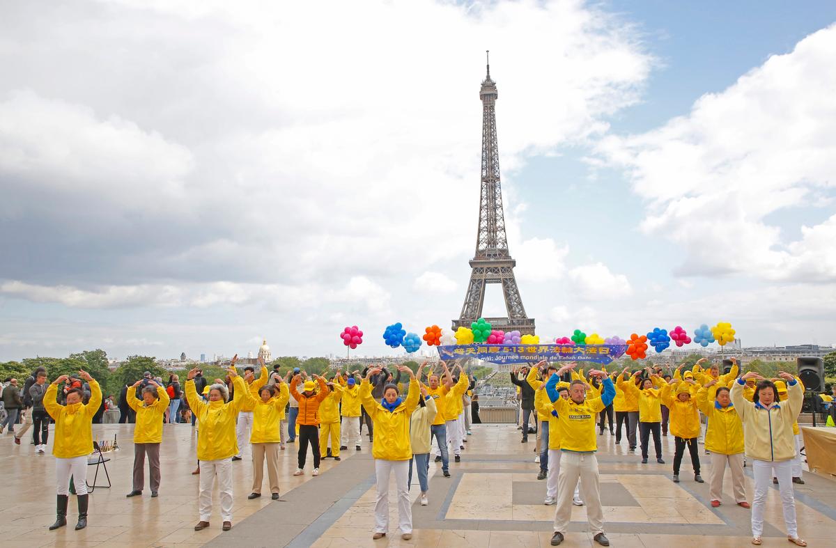 Falun Dafa practitioners in France practicing the second set of exercises at the Trocadéro, Paris, on the 20th anniversary of World Falun Dafa Day on May 5, 2019. (Zhang Le/The Epoch Times)