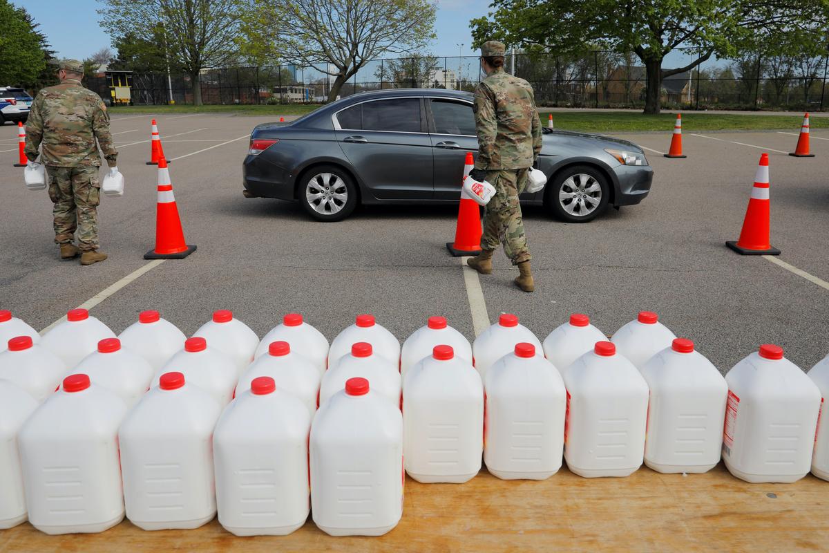 Members of the Massachusetts Army National Guard distribute free milk, offered instead of dairy farmers throwing away excess milk due to lower demand amid the COVID-19 outbreak, in Boston, on May 7, 2020. (Brian Snyder/Reuters)