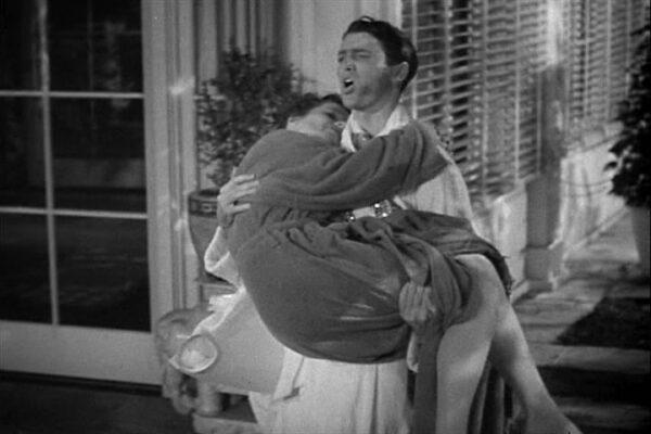Mike (James Stewart) carries Tracy (Katharine Hepburn) after they've dipped into too much Champagne. (MGM)