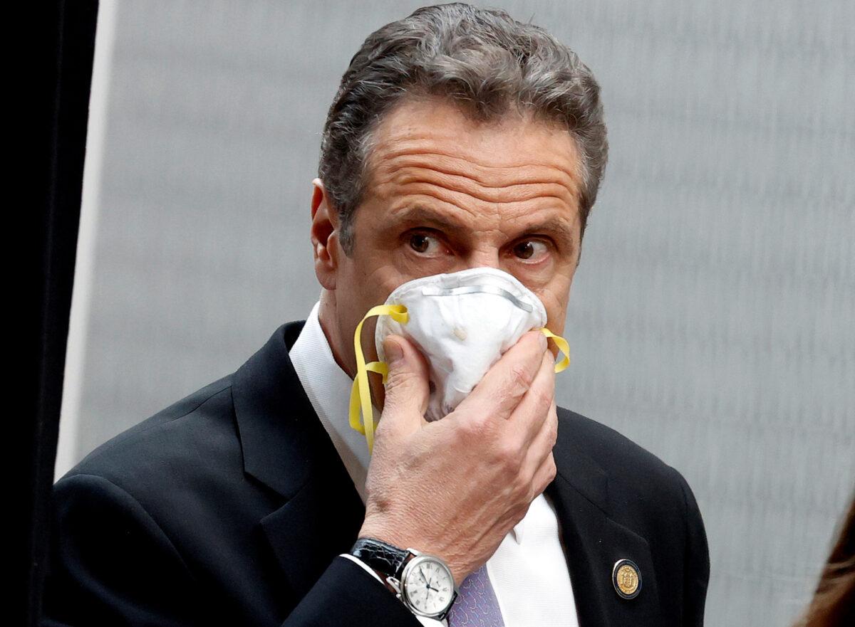 F New York Governor Andrew Cuomo holds a protective mask to his face as he arrives for a daily briefing at New York Medical College during the outbreak of the COVID-19 in Valhalla, New York, May 7, 2020. (File photo by Mike Segar/Reuters)