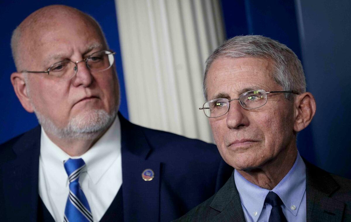 (L-R) Robert Redfield, Director of the Centers for Disease Control and Prevention, and Dr. Anthony Fauci, director of the National Institute of Allergy and Infectious Diseases, attend a briefing on the administration's CCP virus response in the press briefing room of the White House in Washington on March 2, 2020. (Drew Angerer/Getty Images)