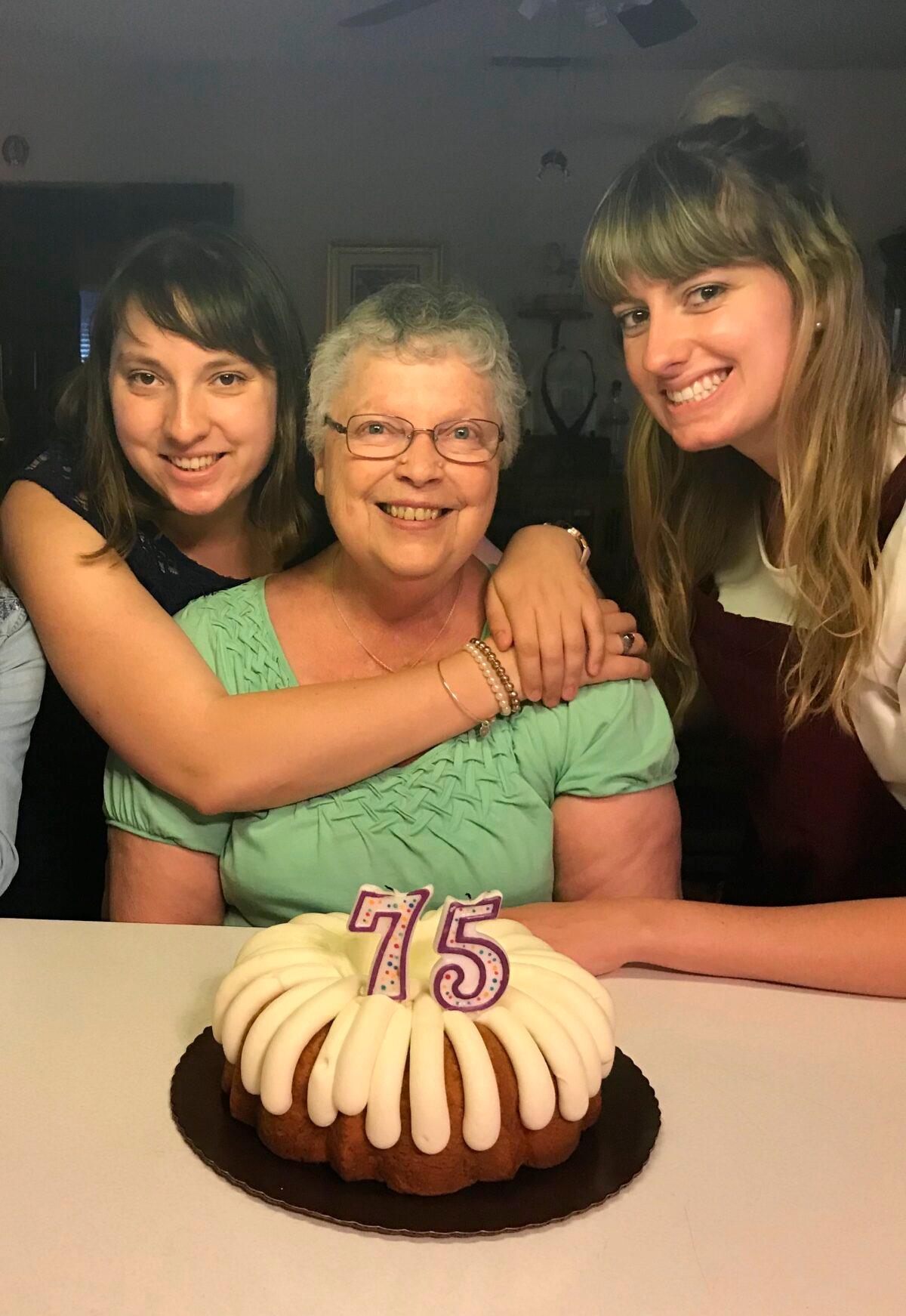 Megan Hockman, her grandmother Eleanor Raguse and sister Kayla Hockman pose with a birthday cake for Raguse in Fontana, Calif., on June 3, 2018. (Lori Hockman via AP)