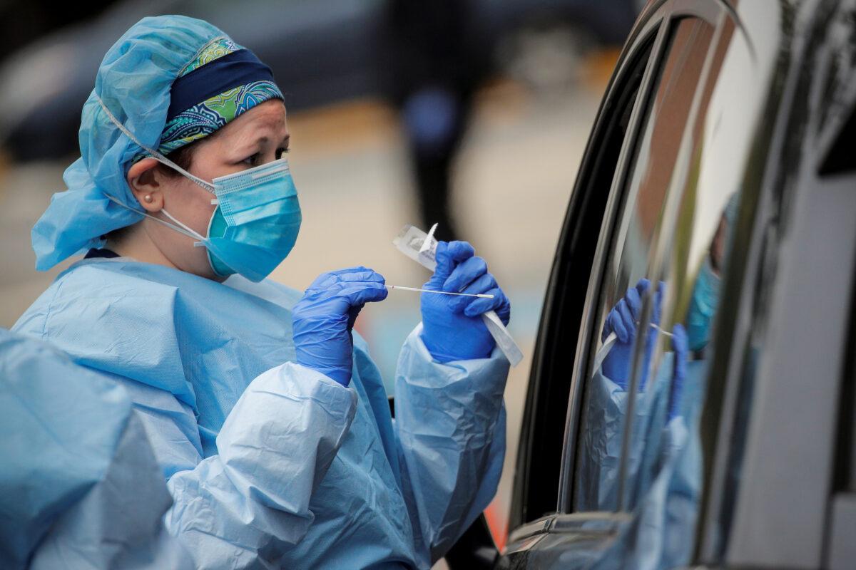 Nurses work at a drive-through testing site for the CCP virus at North Shore University Hospital in Manhasset, N.Y., on May 6, 2020. (Brendan McDermid/Reuters)