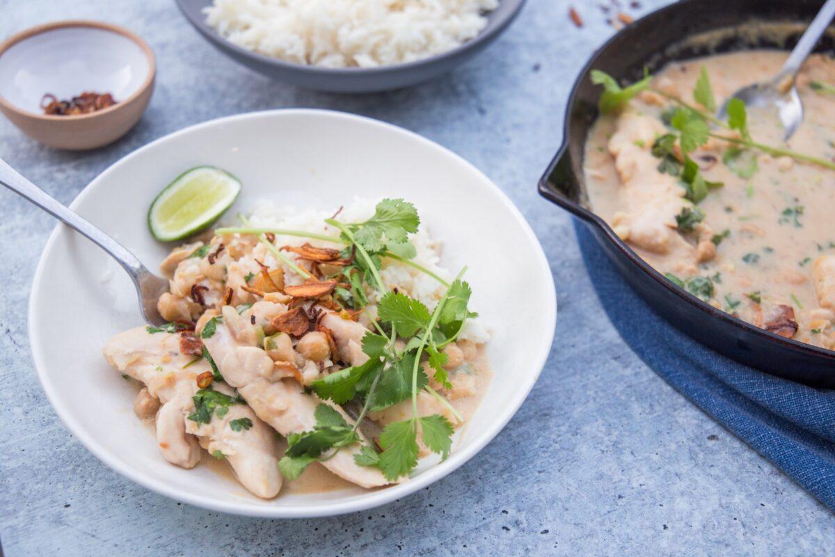 Spoon the chicken, chickpeas, and plenty of creamy coconut-miso sauce over the rice to serve. (Photo by Caroline Chambers)