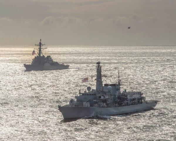 The Royal Navy Type-23 Duke-class frigate HMS Kent (F78), front, and the Arleigh Burke-class guided-missile destroyer USS Donald Cook (DDG 75) conduct joint operations to ensure maritime security in the Arctic Ocean on May 5, 2020. (U.S. Navy photo courtesy of the Royal Navy/Dan Rosenbaum/Released)