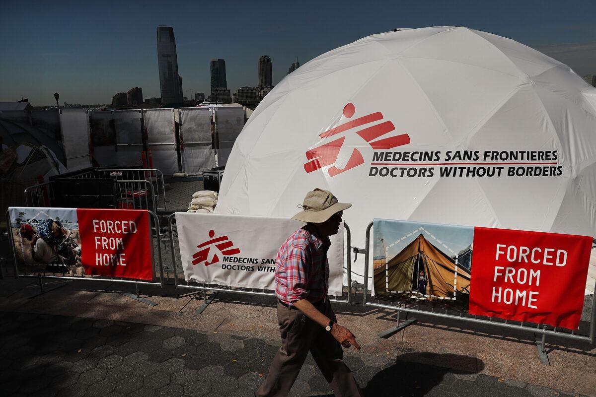People walk by an educational exhibit organized by Doctors Without Borders/Médecins Sans Frontières (MSF), in New York City, on Sept. 23, 2016. (Spencer Platt/Getty Images)