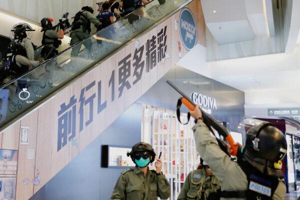 Riot police raise their pepper spray projectile inside a shopping mall as they disperse anti-government protesters during a rally, in Hong Kong, China May 10, 2020. (Tyrone Siu/Reuters)