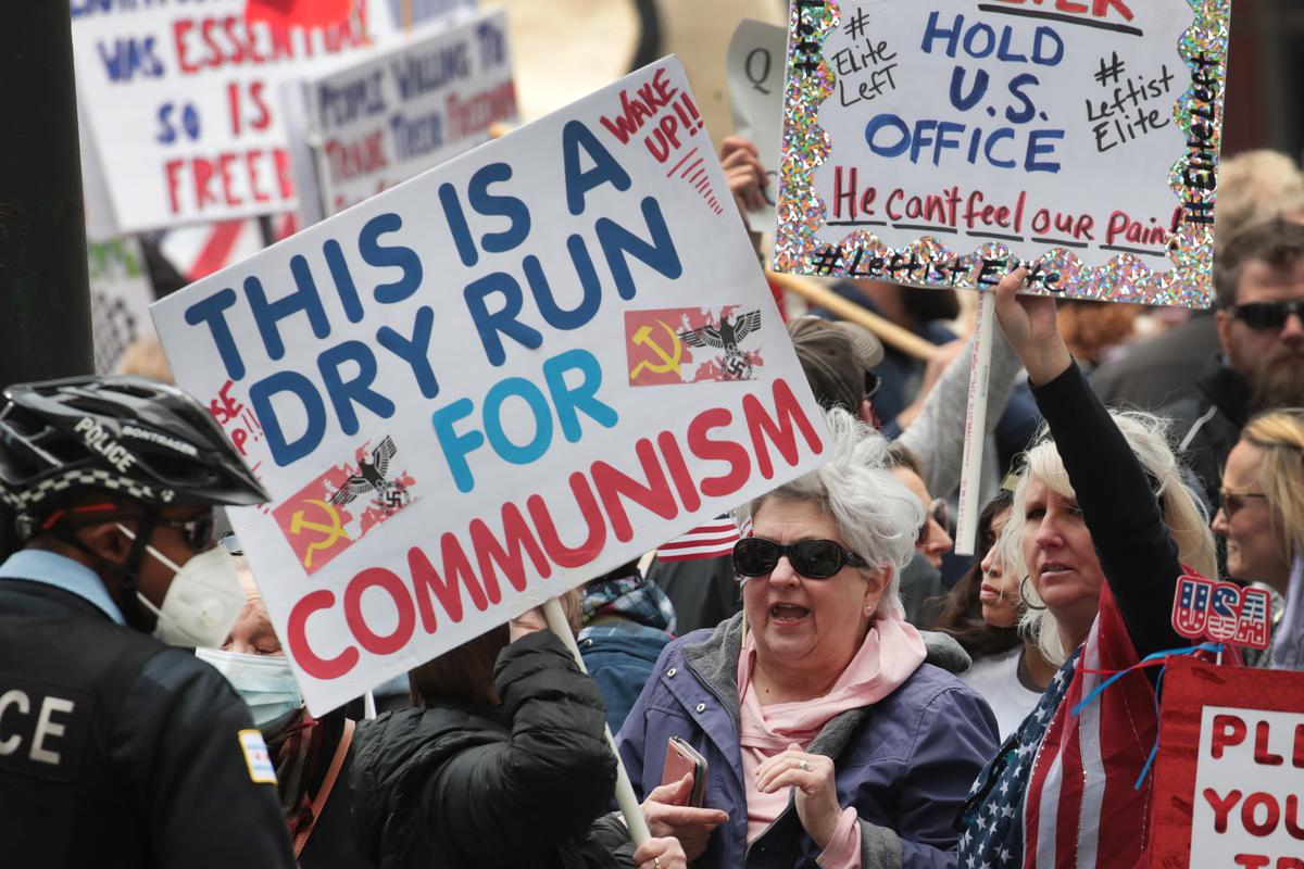 Demonstrators gather outside of the Thompson Center to protest restrictions instituted by Illinois Gov. J.B. Pritzker, in Chicago, Ill., on May 1, 2020. (Scott Olson/Getty Images)