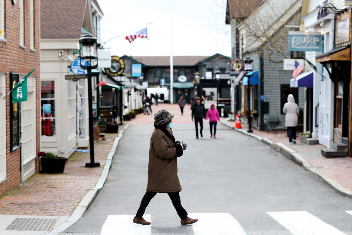 A pedestrian walks past Bannister's Wharf in Newport, R.I. as so-called non-essential retailors reopened, on May 9, 2020. (Maddie Meyer/Getty Images)