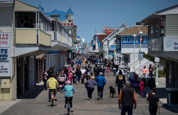 People walk on the boardwalk as the area reopens in Ocean City, Md., on May 10, 2020. (Eric Thayer/Getty Images)