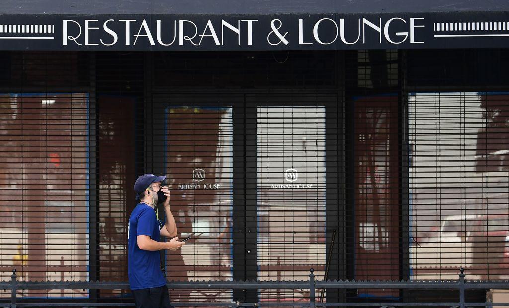 A pedestrian walks past a closed Artisan House restaurant in Los Angeles on May 7, 2020. (Frederic J. Brown/AFP/Getty Images)
