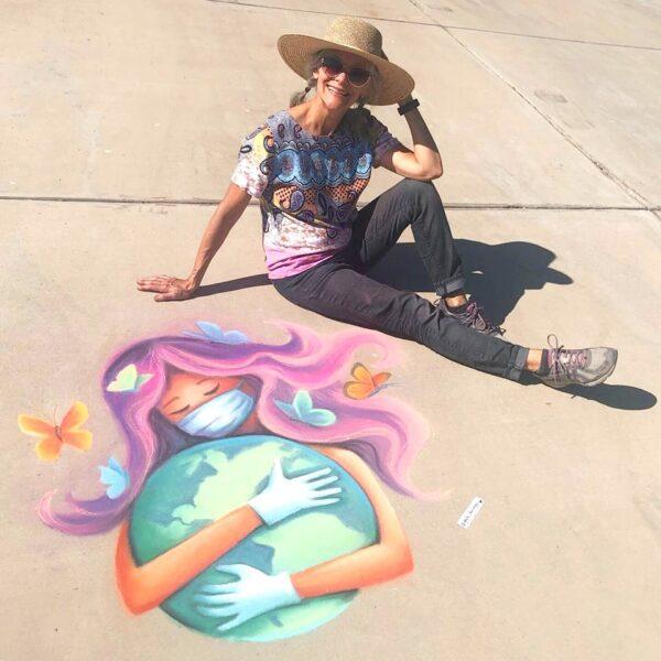 Artist Gayle DuRivage poses with one of her chalk murals. (Courtesy of Gayle DuRivage)