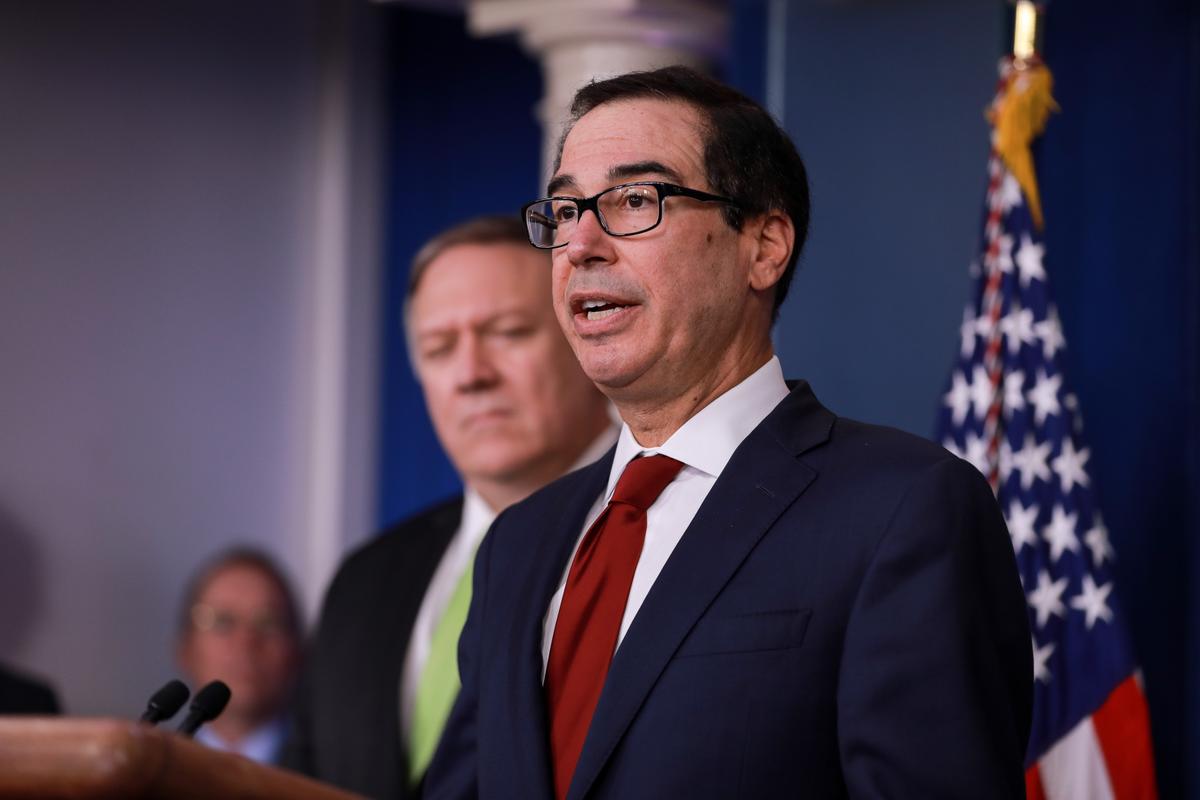 Secretary of the Treasury Steve Mnuchin (R) speaks to media while Secretary of State Mike Pompeo looks on, in the White House briefing room in Washington on Jan. 10, 2020. (Charlotte Cuthbertson/The Epoch Times)