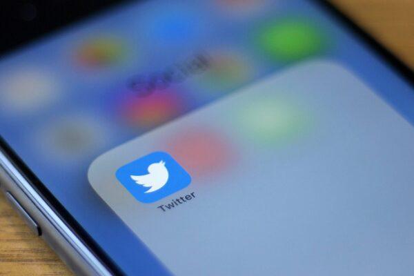 The Twitter logo is seen on a phone in this photo illustration in Washington, on July 10, 2019. (Alastair Pike/AFP/Getty Images)