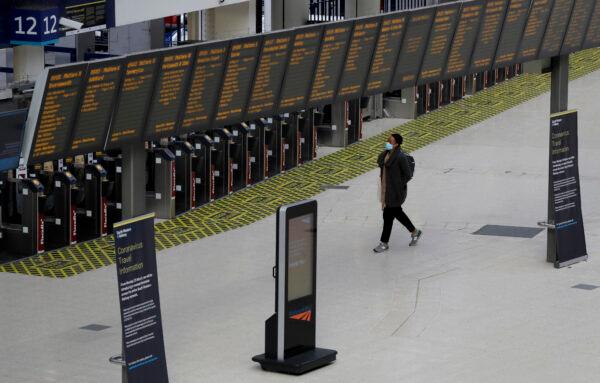 As the UK continues in lockdown to help stop the spread of the CCP virus, a traveler walks through a quiet Waterloo Station during rush hour, London, Britain, on May 13, 2020. (Kirsty Wigglesworth/AP Photo)