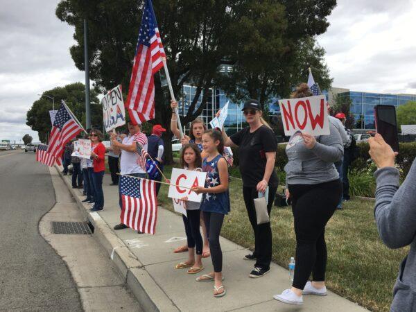 Children and adults show support at the rally in front of Tesla’s corporate office in Fremont, Calif., on May 13, 2020. (Ilene Eng/The Epoch Times)