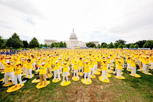 Falun Gong practitioners take part in a rally calling for an end to the persecution of Falun Gong in China, on Capitol Hill in Washington, on June 20, 2018. (Edward Dye/The Epoch Times)