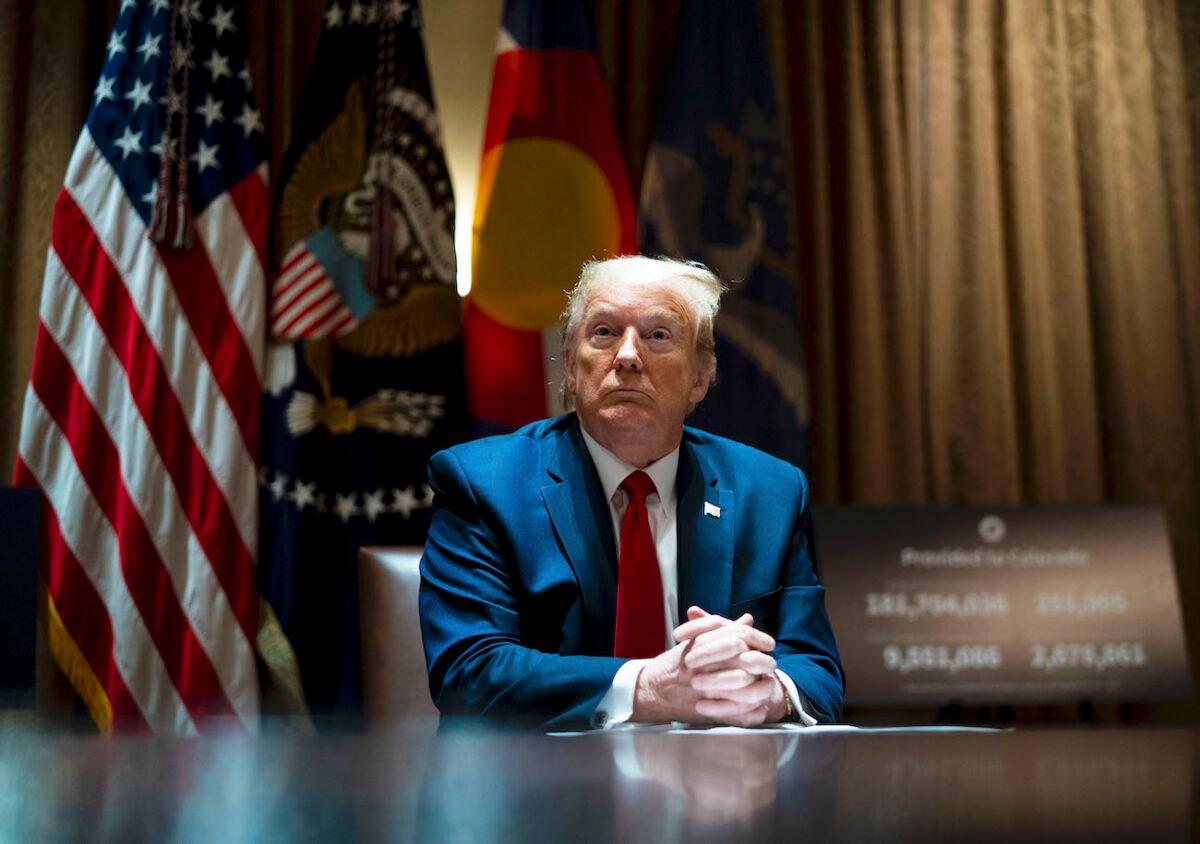 President Donald Trump looks on as he meets with Colorado Gov. Jared Polis and North Dakota Gov. Doug Burgum in the Cabinet Room of the White House in Washington, on May 13, 2020. (Doug Mills-Pool/Getty Images)