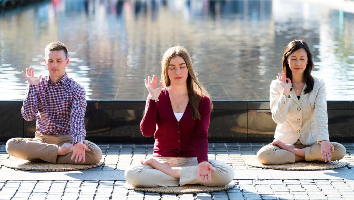 Amy Isabelle Duncan (C) and two others practice the Falun Dafa meditation at a park in Sydney on June 26, 2017. (Courtesy of Emma Morley)