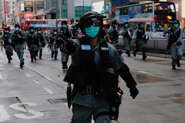Riot police disperse protesters during a protest at Mong Kok in Hong Kong, China on May 10, 2020. (Tyrone Siu/Reuters)