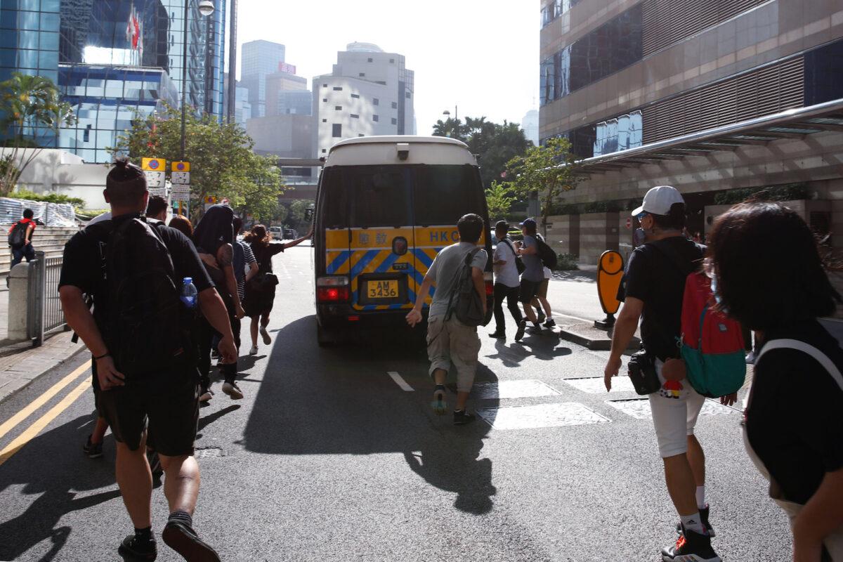 Supporters chase a prison van after an anti-government protester Sin Ka-ho has been sentenced four years for rioting, in Hong Kong, China on May 15, 2020. (Tyrone Siu/Reuters)