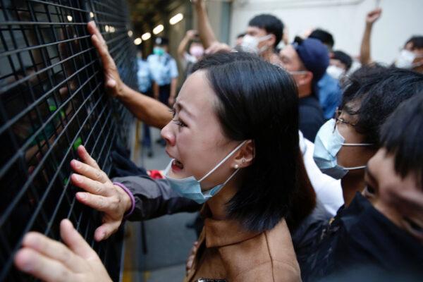 A family member cries and bid farewell to a prison van after an anti-government protester Sin Ka-ho has been sentenced four years for rioting, in Hong Kong, China on May 15, 2020. (Tyrone Siu/Reuters)