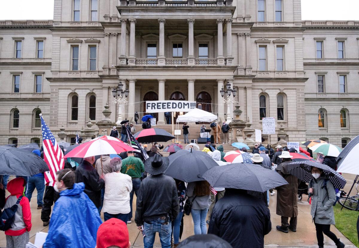 People gather to protest against Gov. Gretchen Whitmer's extended stay-at-home orders intended to slow the spread of COVID-19 at the Capitol building in Lansing, Mich. on May 14, 2020. (Seth Herald/Reuters)