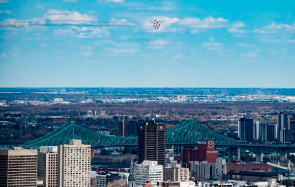 The Snowbirds, the Royal Canadian Air Force air acrobatics team, fly over Montreal in a morale-building tour of Canada called "Operation Inspiration" on May 7, 2020. (Sebastien St-Jean/AFP via Getty Images)