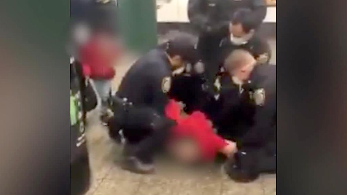 NYPD officers arrest woman in a subway station for allegedly striking officer after she didn't wear a face mask as required on May 13, authorities say. (Courtesy Anthony Davis via CNN)