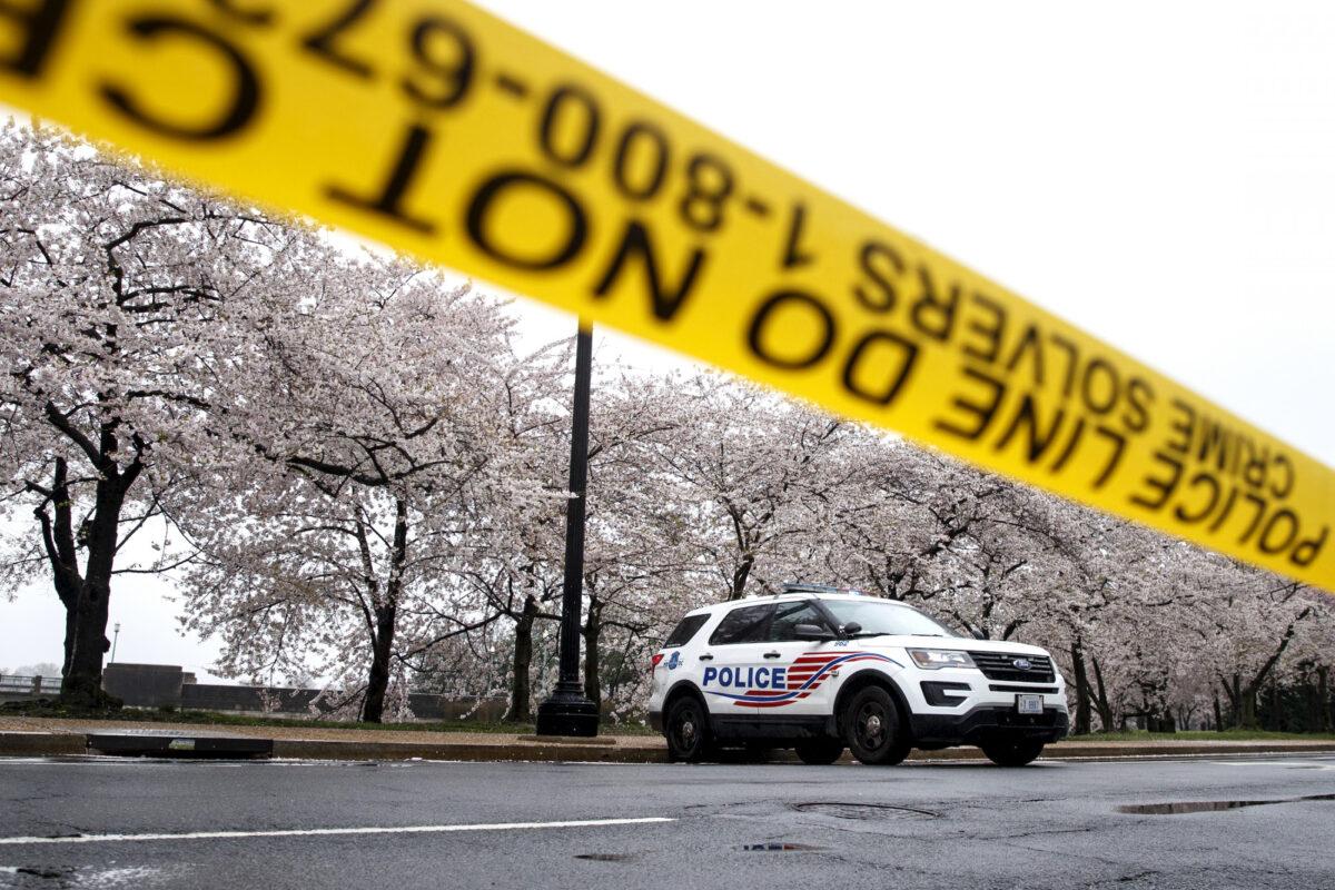 A Washington, D.C. Metropolitan Police vehicle is parked on the other side of police tape on March 23, 2020. (Carolyn Kaster/AP Photo)