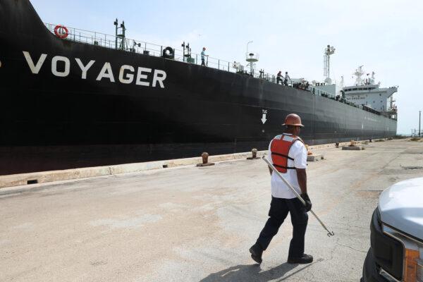 A line handler helps dock the oil tanker, Texas Voyager, as it pulls into its mooring to offload its crude oil at Port Everglades in Fort Lauderdale, Fla., on April 21, 2020. (Joe Raedle/Getty Images)
