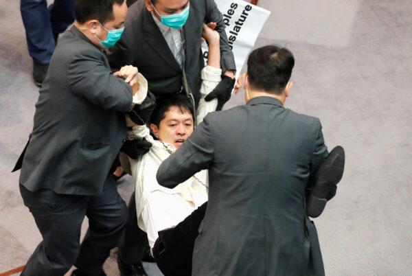 Pan-democratic legislator Hui Chi-fung is being taken away by security during Legislative Council’s House Committee meeting, in Hong Kong, China, on May 18, 2020. (Tyrone Siu/Reuters)