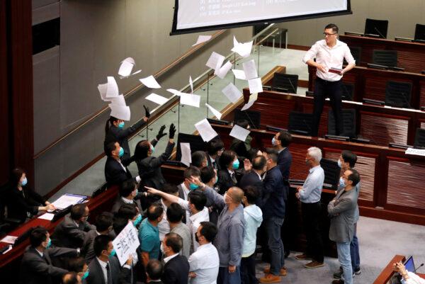Pan-democratic legislator Lam Cheuk-ting tears the paper of Rule of Procedure during Legislative Council’s House Committee meeting, in Hong Kong, China, on May 18, 2020. (Tyrone Siu/Reuters)