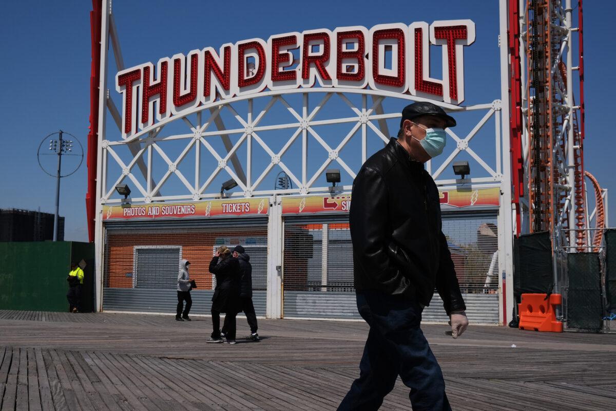 People on a boardwalk at Brooklyn's Coney Island, in New York City, on April 25, 2020. (Spencer Platt/Getty Images)