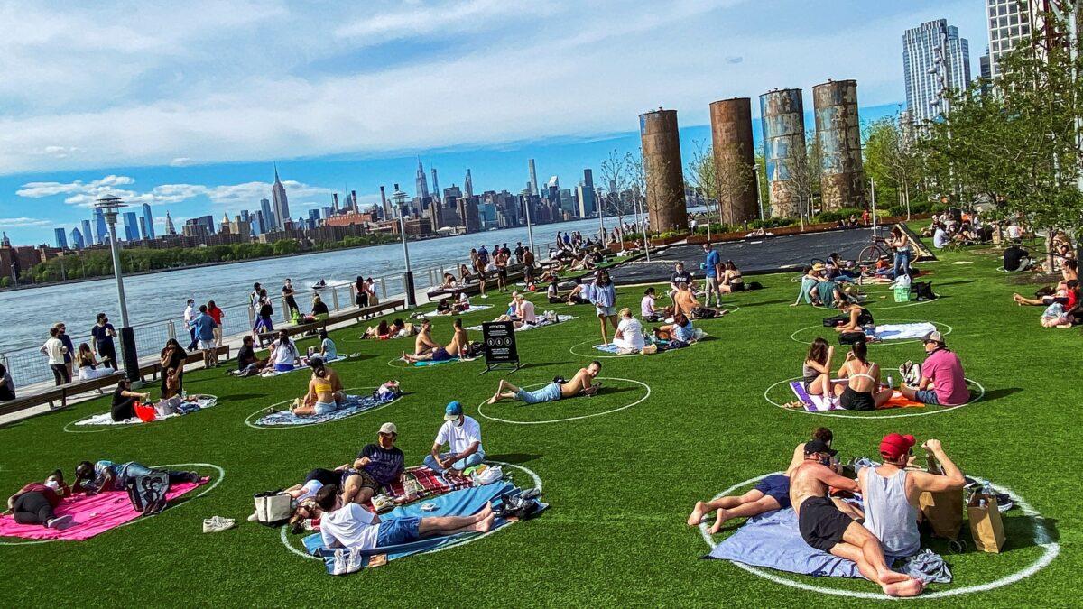 People enjoy a warm day during the CCP virus outbreak at Domino Park in Brooklyn, New York City, on May 16, 2020. (Eduardo Munoz/Reuters)