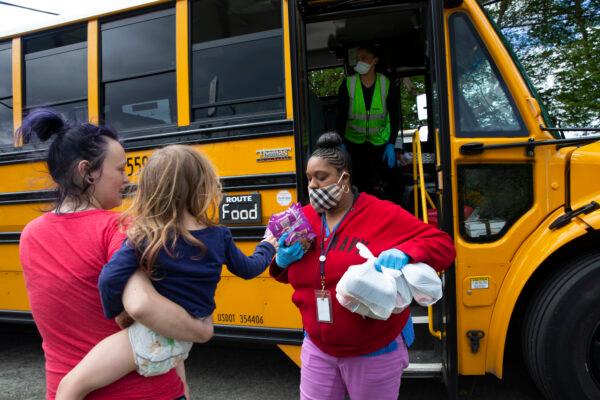 School bus driver delivers meals to children and their families in Seattle, Wash., on May 6, 2020. (Karen Ducey/Getty Images)