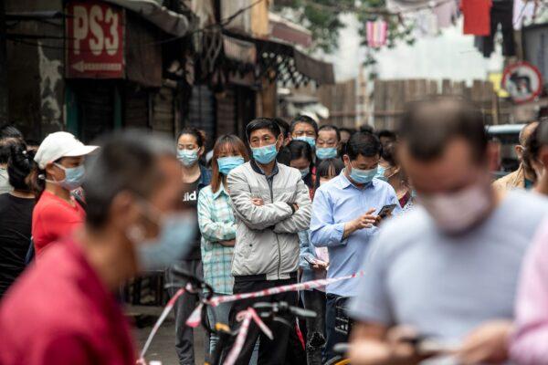 Residents wait in line to provide swab samples to be tested for the COVID-19 coronavirus, in a street in Wuhan in China's central Hubei province on May 15, 2020. (STR/AFP via Getty Images)