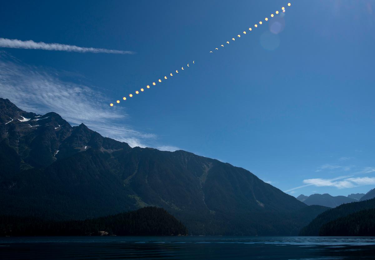 A composite image by NASA depicting the progression of a partial solar eclipse over Ross Lake in Northern Cascades National Park, Washington, on Aug. 21, 2017 (Bill Ingalls/NASA via Getty Images)